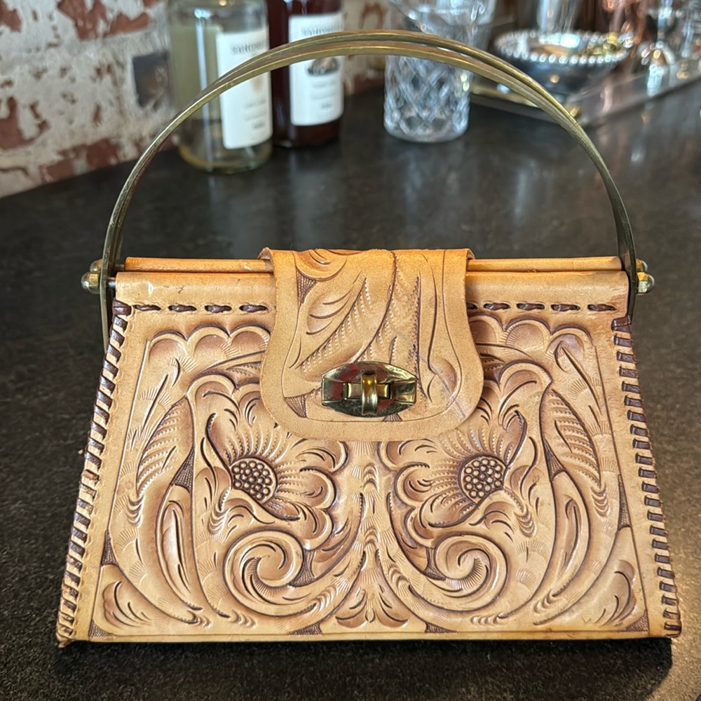 Vintage tooled leather bag with brass handles